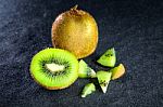 Kiwi Fruit On Black Stone Low Key Light Stock Photo