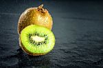 Kiwi Fruit On Black Stone Low Key Light Stock Photo