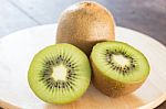 Kiwi Fruit On Brown Wooden Background Stock Photo