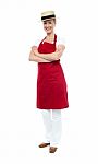 Lady Chef Standing With Arms Folded Stock Photo