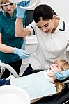 Lady Dentist Checking Girl's Teeth Stock Photo