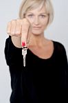 Lady Displaying Key To Camera Stock Photo