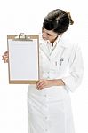 Lady Doctor Looking In Clipboard Stock Photo