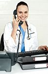 Lady Doctor Talking Over Phone Stock Photo