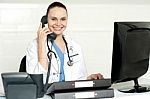 Lady Doctor Talking Over Phone Stock Photo