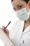 Lady Doctor With Pad And Mask Stock Photo