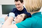 Lady Getting Her Teeth Cleaned By Dentist Stock Photo