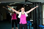 Lady Holding Dumbbells In Her Outstretched Arms Stock Photo