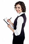 Lady In Waist Coat Taking Down Instructions Stock Photo