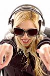 Lady Pointing Forward With Earphone Stock Photo