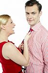 Lady Pulling Tie Her Husband Stock Photo