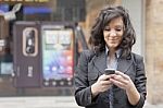 Lady Reading Sms In Street Stock Photo