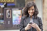 Lady Reading Sms In Street Stock Photo