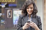 Lady Reading Sms In Street Stock Photo