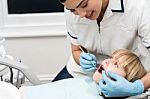 Lady Stomatologist Checking Childs Teeth Stock Photo