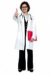 Lady Surgeon Gesturing Thumbs Up Stock Photo