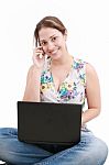 Lady Talking Over Phone With Laptop Stock Photo