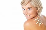 Lady With Sun Tan Lotion On Her Back Stock Photo