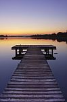 Lake Pier At Sunset Stock Photo