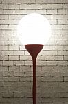 Lamp With Circle Shape On White Bricks Background Vertical Stock Photo