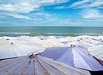 Large Umbrella Crowded Along Cha-am Beach Stock Photo