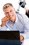 Laying Man With Notebook And Looking At Camera Stock Photo