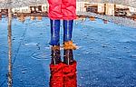 Legs Of Little Girl Standing In A Pool Of Autumn Stock Photo