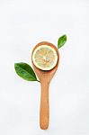 Lemon Slices On Wooden Spoon With Leaf Isolated Stock Photo