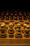 Light And Dark Wooden Chess Pieces On Chess Table Stock Photo