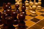 Light And Dark Wooden Chess Pieces On Chess Table Stock Photo