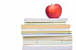 Light Red Apple On Book Stack Stock Photo