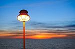 Lighting Of Warm Lamp And Lighting Of Sunset At Sea Stock Photo