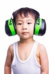 Little Asian Boy In A White Singlet Wearing Earmuffs Stock Photo