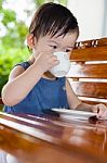 Little Asian Girl (thai) Drinking From A Cup Stock Photo