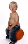 Little Boy On A Pumpkin Stock Photo