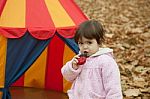 Little Girl Eats  In The Park Stock Photo