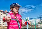 Little Girl In A Safety Helmet Riding A Bicycle Stock Photo