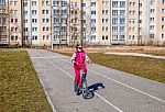 Little Girl In A Safety Helmet Riding A Bicycle Stock Photo