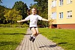 Little Girl Jumping Rope Outside Stock Photo