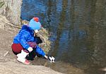 Little Girl Playing With Paper Boat Stock Photo