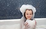 Little Girl Playing With Soap Suds  In A Bath Stock Photo