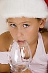 Little Girl With Christmas Hat And Glass Stock Photo