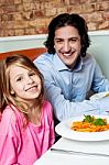 Little Girl With Her Father In Restaurant Stock Photo