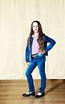 Little Girl With Long Hair In A Blue Denim Suit Stock Photo