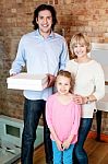 Little Girl With Parents Posing Casually Stock Photo