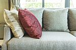 Living Room With Row Of Pillows On Sofa At Home Stock Photo