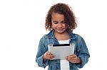 Llittle Girl Looking Digital Tablet Stock Photo