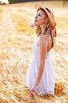 Lonely Beautiful Young Blonde Girl In White Dress With Straw Hat Stock Photo