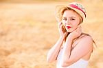 Lonely Beautiful Young Blonde Girl In White Dress With Straw Hat Stock Photo