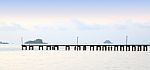 Long Wooden Pier Port On Morning Beach Stock Photo